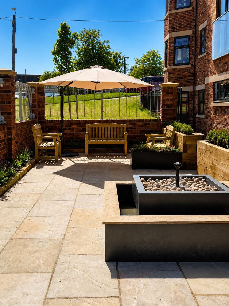 The courtyard garden with benches, parasol and water feature