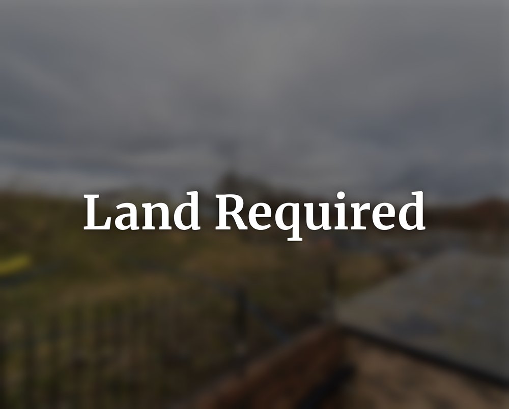 A softly blurred development site under a cloudy sky, with the words Land Required
